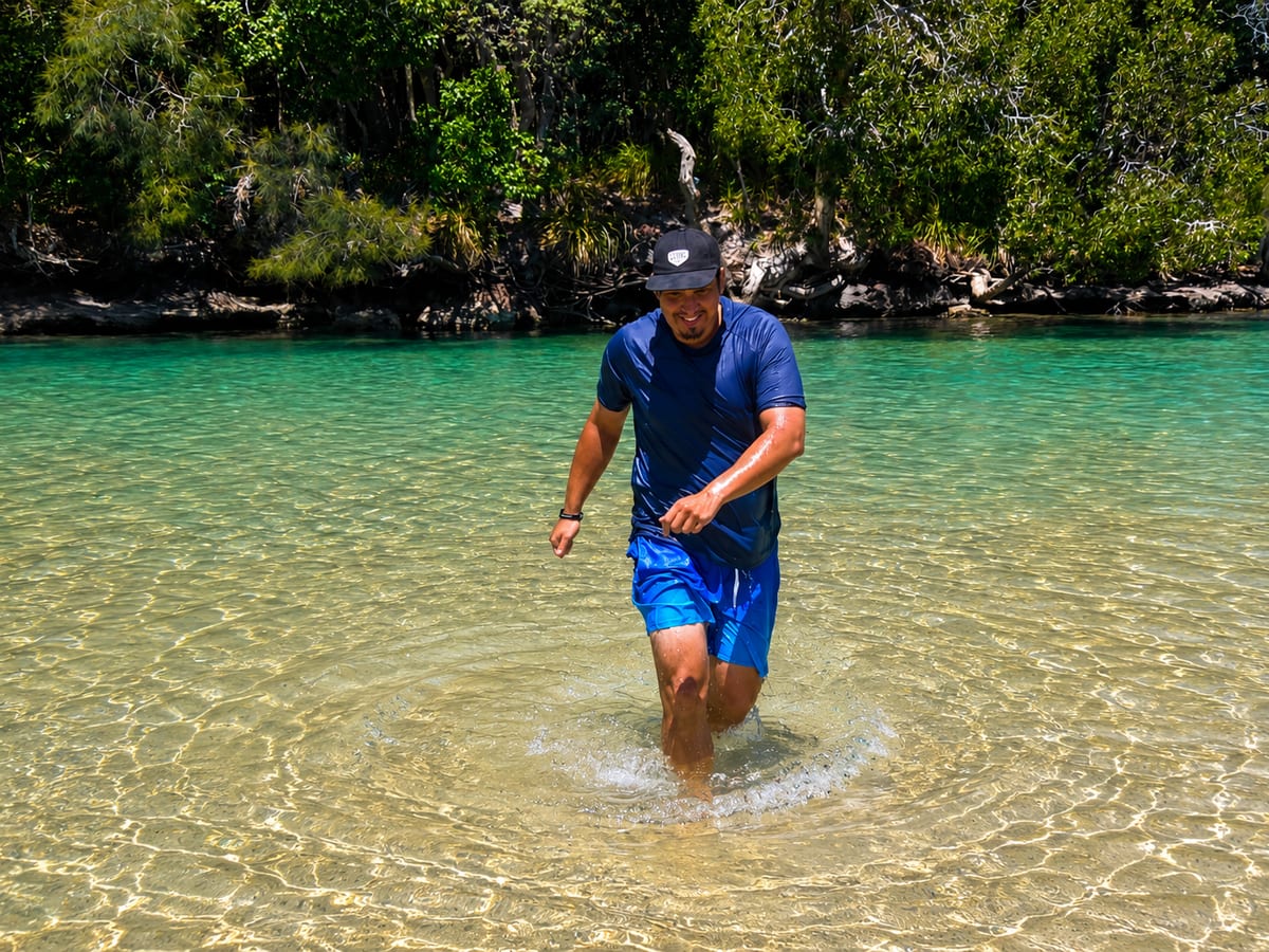 Wading through clear shallow water on a warm day.